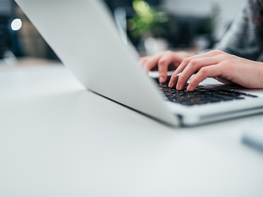 person typing on a laptop