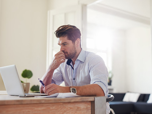 man deep in thought working at his desk
