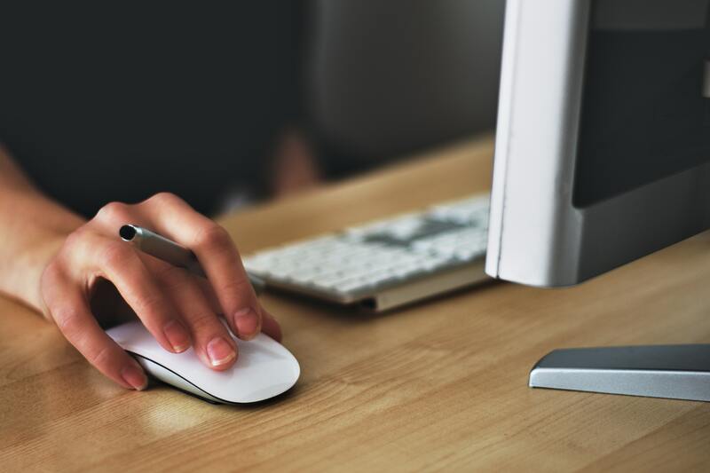 close up of a hand on a wireless mouse