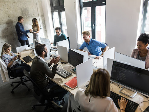 group of people working together on a project on their desktops